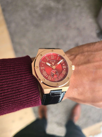 Close-up of VEMPIRE Phoenix Rose Gold Red watch on wrist